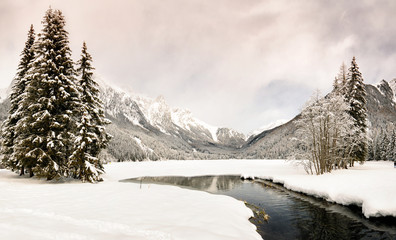 Fototapeta na wymiar Beautiful Winter scene on frozen Antholz Lake, Val Pusteria, Italy.