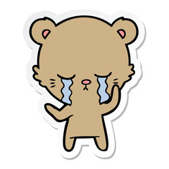 sticker of a crying cartoon bear