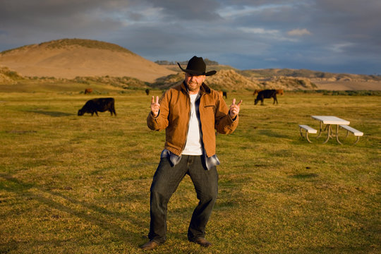 Man in cowboy hat standing in a farm field