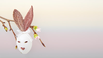 Ester egg with bunny ears, cherry branch
