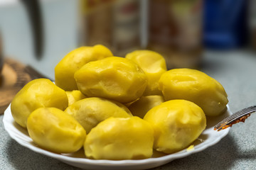 peeled potatoes lie on a plate. Concept: food and nutrition