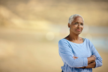 Portrait of a senior woman standing on a beach.