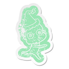 cartoon distressed sticker of a weird bald spaceman running wearing santa hat