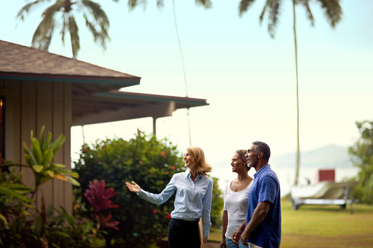 Real estate agent showing the house to her clients.