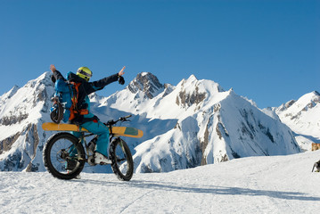 man with an electric bike, e-bike, ebike, mountains of Formazza Valley, ski loaded on bicycle, on path with snow and continue with skis, winter, sport, adventure, travel, Alps, Piedmont, italy