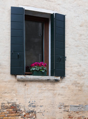 Fototapeta na wymiar Window of a house on the street in Venice