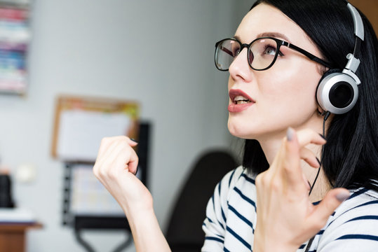 Young beautiful girl with headphones learns language