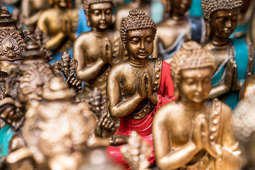 Fototapeta na wymiar Buddha statue figures sold as a souvenir on a market