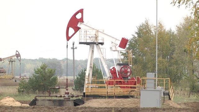 The pumping unit as the oil pump installed on a well. Equipment of oil fields. Operating oil and gas well. The pumping unit as the oil pump installed on a well. Equipment of oil fields.