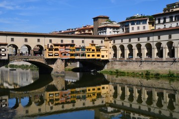 Fototapeta na wymiar Florence in Italy. Ponte Vecchio on a sunny day. The famous medieval bridge over the Arno river, in Florence, Italy.