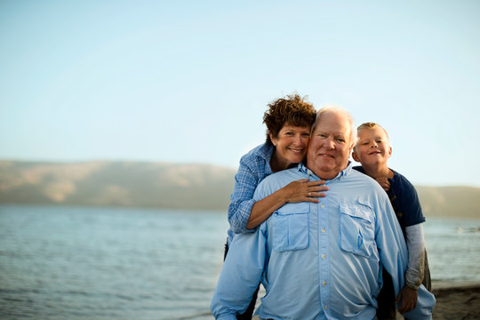 Portrait of a happy mature couple posing with their young grandson.