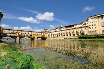 Florence in Italy. Ponte Vecchio on a sunny day. The famous medieval bridge over the Arno river, in Florence, Italy.