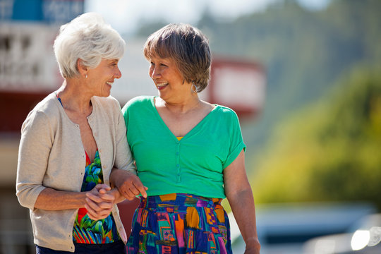 Two smiling senior women having fun while on summer holiday together.