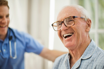 Smiling senior man with male nurse