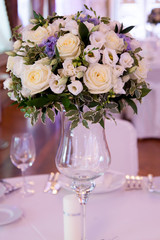 Banquet decorated table, with cutlery. Wedding decor in the banquet hall. Serving of a festive table, plate, napkin, knife, fork. Table setting decoration. Romantic Dinner or other events - wedding.