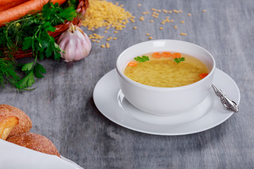 Bouillon or broth served in bowls on a rustic wood table