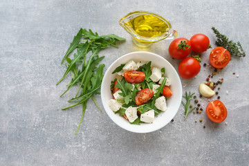 Italian cuisine. Vegetarian food. Salad with mozzarella, arugula and cherry tomatoes.