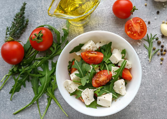 Italian cuisine. Vegetarian food. Salad with mozzarella, arugula and cherry tomatoes.