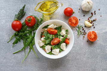 Italian cuisine. Vegetarian food. Salad with mozzarella, arugula and cherry tomatoes.