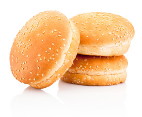 Three hamburger buns with sesame isolated on a white background