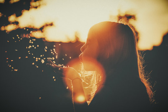 girl blowing little hearts