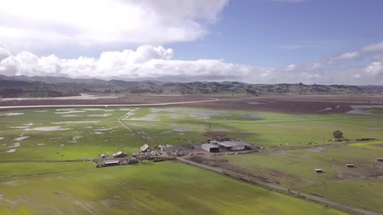 Aerial rising shot of farms and mountains in Sonoma County, California.