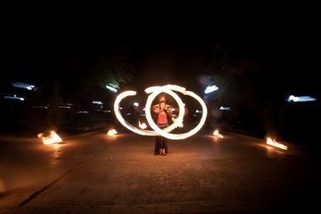 Amazing fire show dance. Fire dancers playing with flame