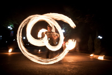 Amazing fire show dance. Fire dancer playing with flame