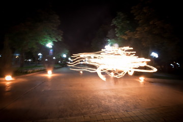 Amazing fire show dance. Fire dancer playing with flame