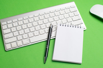 Laptop with notepad and pen