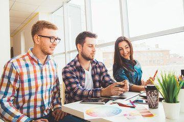 Group of international university students having fun studying in library, three colleagues of...