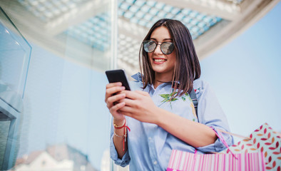 Shopping time. Modern young woman enjoying in shopping. Consumerism, shopping, lifestyle concept