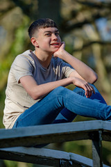 Obraz premium Teenage boy outside on a bright Spring day