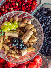Ingredients for a healthy breakfast, nuts, berries, fruits, food for heart, rich with resveratrol, vitamin, antioxidants Top view