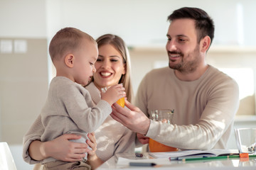Family with child making juice at home