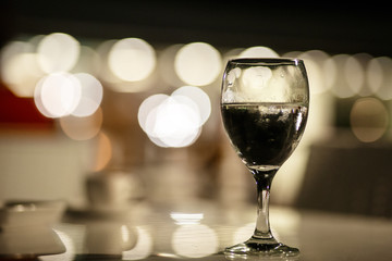 Glass glass glass with water on the background of lights