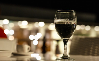 Glass glass glass with water on the background of lights