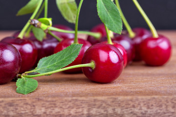 A bunch of ripe sweet cherries on a wooden table board