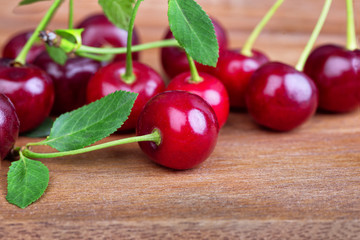 A bunch of ripe sweet cherries on a wooden table board