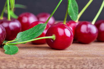 A bunch of ripe sweet cherries on a wooden table board