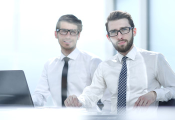 two business colleagues sitting at the Desk.