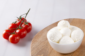 Fresh cherry tomatoes and mozzarella on white background
