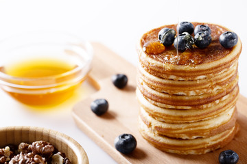 Fresh homemade pancakes with blueberries and syrup