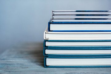 stack of books lying on a wooden surface