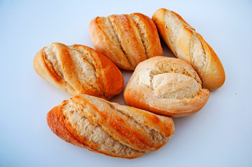Five toasted small breads on the white background, side view