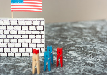 imitation of people against a wall border, bricks on white with an American flag