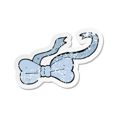 retro distressed sticker of a cartoon bow tie
