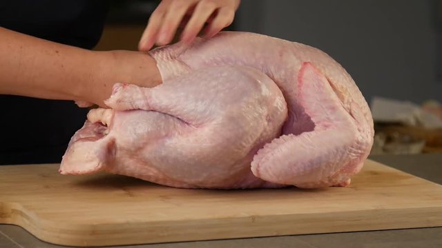 Person separates raw turkey from skin