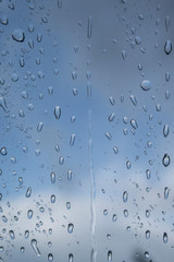 Raindrops running down a window after a rainshower