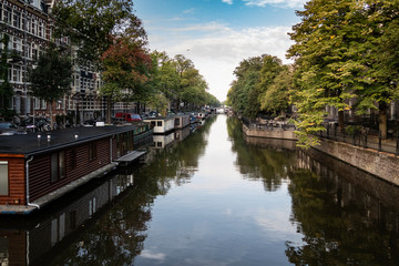Fototapeta premium Houseboats on a canal in Amsterdam